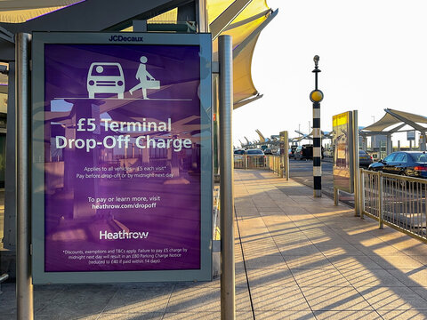 London, England, UK - January 2023: Warning sign informing drivers of a charge to drop off passengers at Terminal 5 at Heathrow Airport.
