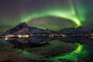 Aurora like a Rainbow is mirroring in the Fjord - 582793568