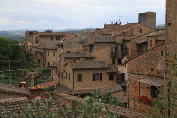 Tiled roofs of ancient ocher houses in the mystical Italian city of Volterra.