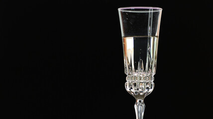 On a holiday, champagne is poured into a crystal glass.