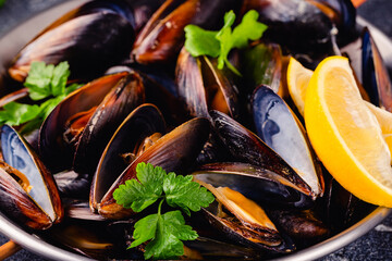 Delicious seafood mussels with sauce and parsley.