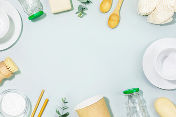 Sustainable kitchen cleaning concept. Eco friendly still life with dishes, cups, bamboo brushes,...