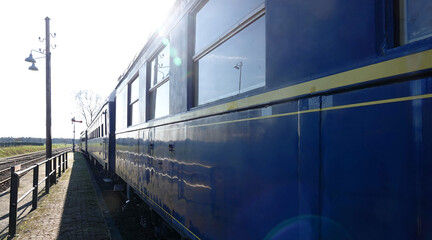 Blue wagons from an old train. There is some lens flare on the picture