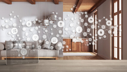 Tablet wireless with smart home app on wooden table, geometric background with connected line and dots showing internet of things system, home automation, kitchen and living room