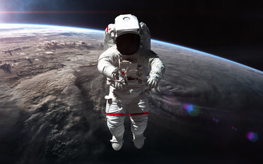 Astronaut in orbit of planet Earth. Solar system. Science fiction. Elements of this image furnished by NASA