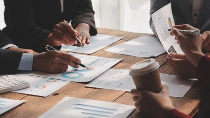 Financial analysts analyze business financial reports on a digital tablet planning investment project during a discussion at a meeting of corporate showing the results of their successful teamwork.
