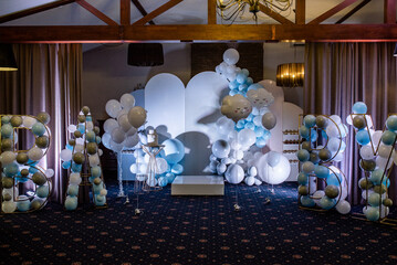 a trendy scenery in the background of the photo zone. Birthday Cake on a background balloons party decor.