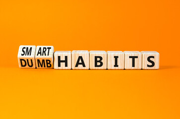 Smart or dumb habits symbol. Concept word Smart habits and Dumb habits on wooden cubes. Beautiful orange table orange background. Business smart or dumb habits concept. Copy space.