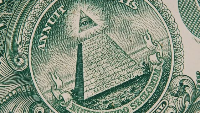 Mason sign symbol of the all-seeing eye sign rotates on a one dollar bill close-up. US banknote in macro with pyramid and eye on top. New world order, elite. Concept inflation, economy, conspiracy. 4K