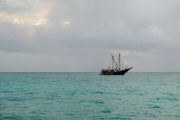 Lone ship with sails in a calm ocean