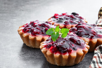 Delicious fruit tarts on gray background