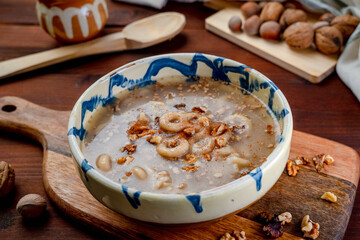 Romania traditional food desert Macinici or Mucenici on traditional plate and dark wood table