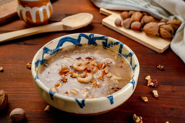 Romania traditional food desert Macinici or Mucenici on traditional plate and dark wood table