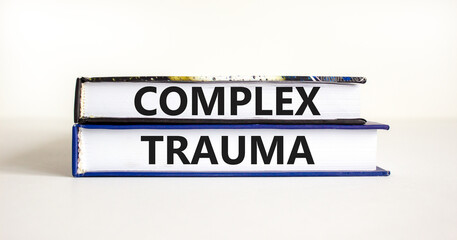 Complex trauma symbol. Concept words Complex trauma on books. Beautiful white table white background. Business psychology complex trauma concept. Copy space.