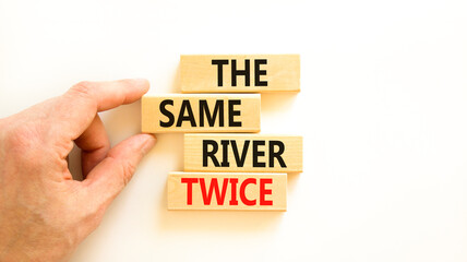 The same river twice symbol. Concept words The same river twice on wooden block. Beautiful white table white background. Motivational business the same river twice concept. Copy space.