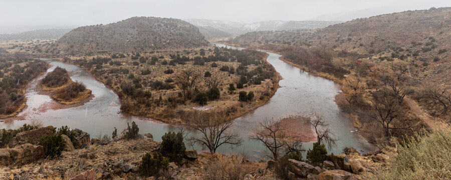 Panorama of epic bend in Rio Grande river on rainy morning in rural New Mexico