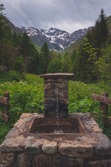 A water fountain on a hiking path in the Alpes mountains
