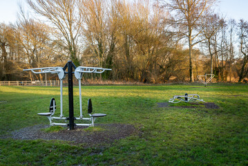 Outdoor gym exercise equipment at public park sports area. Weights and resistance training.