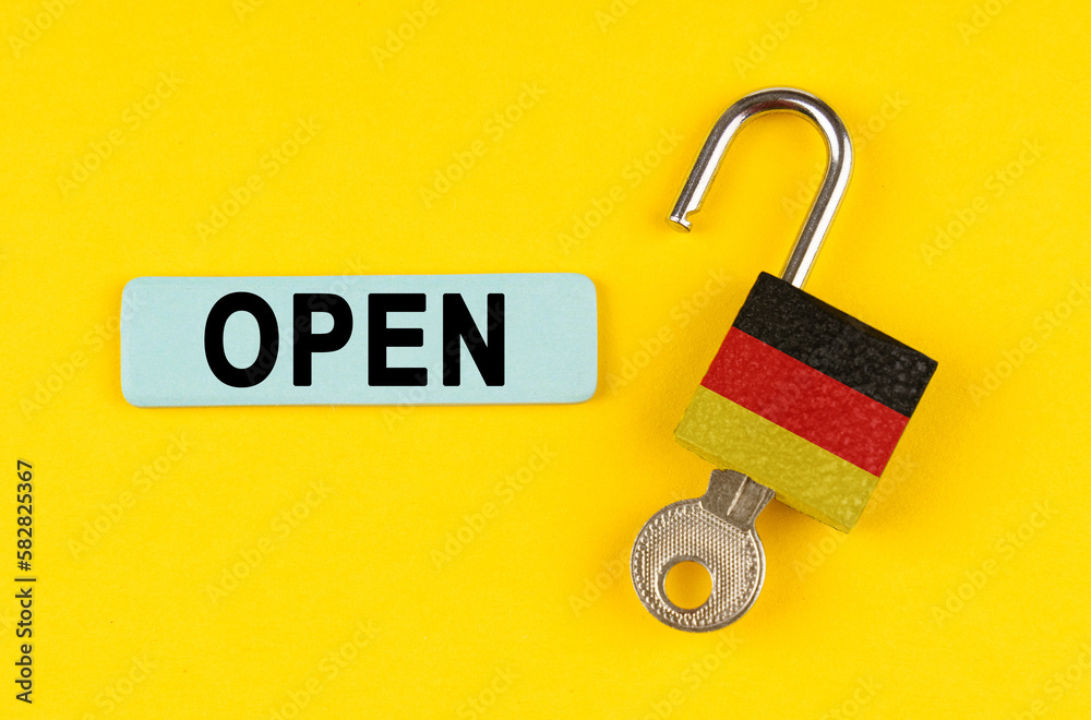 Aufkleber on the yellow surface is an open lock with a key and a sticker with the inscription - open