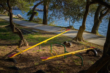 A playground with two seesaws at the sea
