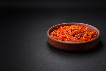 Dried squid chopped into slices and seasoned with sesame seeds and spices