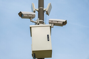 Security CCTV camera monitoring system with panoramic view outdoor against blue sky. Safety system