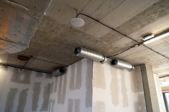 Silencer for circular ducts. Industrial noise reduction from ventilation system in a modern building.