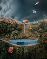 view of an abandoned train station over a water lagoon "Stacja kolejowa Pilchowice Zapora" © Jakub