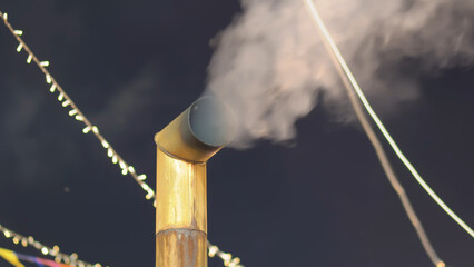 chimney on the roof releasing smoke