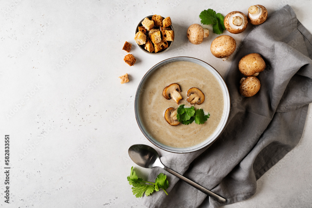 Wall mural Mushroom soup close up with ingredient on white table