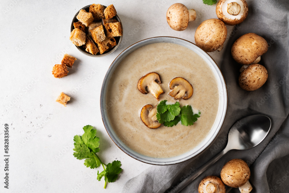 Wall mural Mushroom soup close up with ingredient on white table