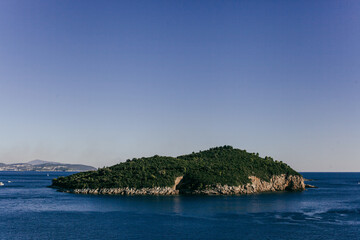 Fototapeta premium Landscape of the Adriatic Sea, mountains with clouds, sky, rocks on a sunny day. Dalmatia, Croatia.