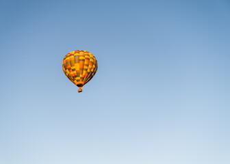 Colourful hot air balloon high up in the air with blue sky in Magaliesburg mountain, Gauteng, South Africa