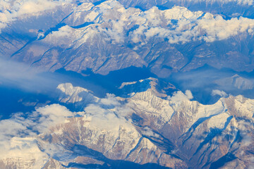 View of the Swiss Alps covered with snow from airplane