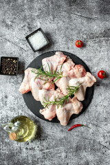 raw chicken wings on stone background