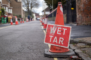 wet tar repair sign