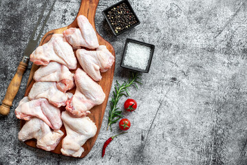 raw chicken wings on stone background with copy space for your text
