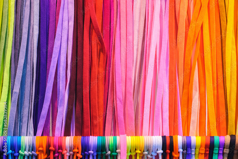 Poster mix colorful hanging vertical stripe textile, fabrics, cloths on the rack. texture of multicolored f