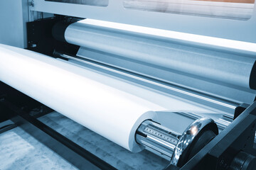 Rolls paper and fabric in wide industrial plotter