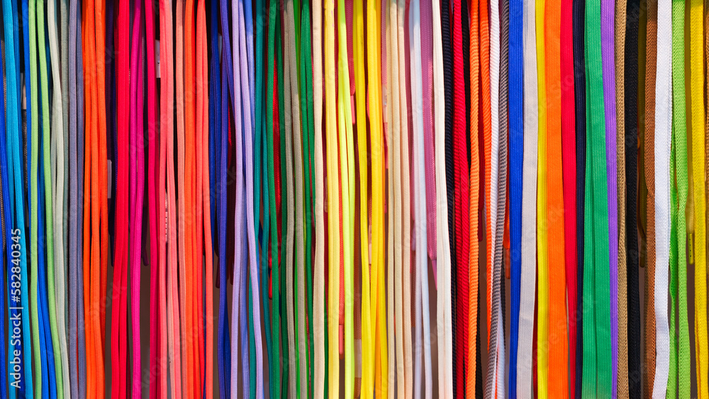 Aufkleber mix colorful hanging vertical stripe textile, fabrics, cloths on the rack. texture of multicolored f