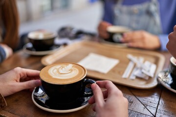 Fototapeta na wymiar Friends taking a tea break at a cozy café.