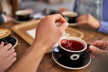 Friends taking a tea break at a cozy café.
