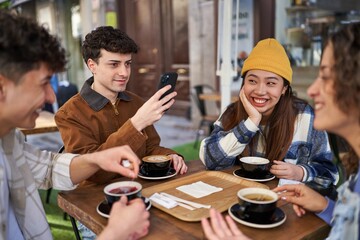 Friends from diverse cultures share laughs over coffee and tea.