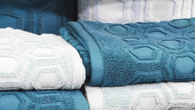 Blue and white folded towels stack closeup picture, hotel service concept backgroundbackground