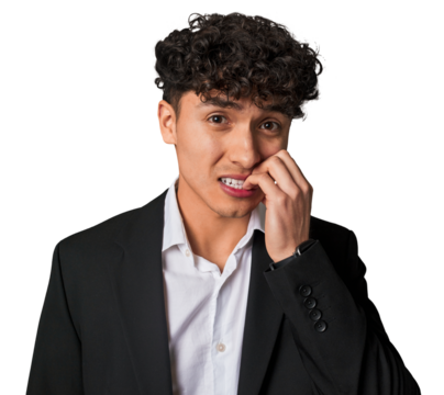 A young latin business man in suit biting fingernails, nervous and very anxious.