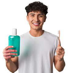 A young man promotes daily dental hygiene, holding a toothbrush and mouthwash for fresh breath,...