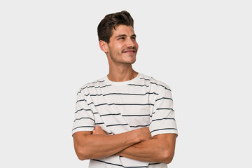 Young handsome caucasian man isolated on white background dreaming of achieving goals and purposes