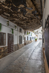 Exposure of Setenil de las Bodegas famous for its dwellings built into rock overhangs above the Río Guadalporcún, Cadiz, Spain