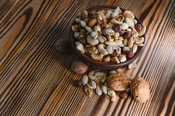 Various nuts on a plate, top view.