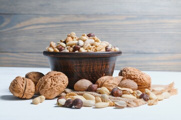 Mixed nuts on wood floor. Organic and fresh nuts. Copy space